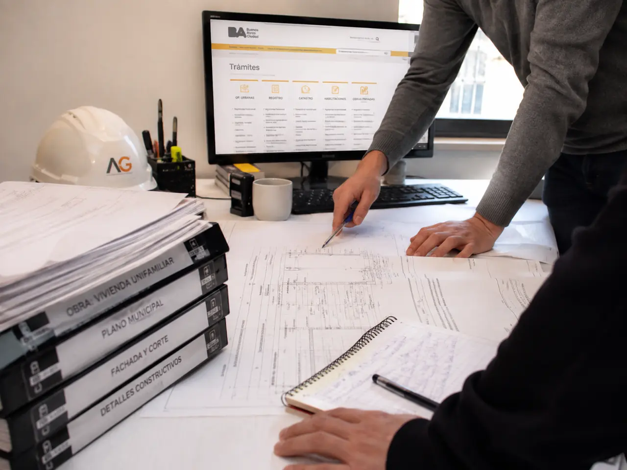 Technical office table with municipal drawings and documents under review